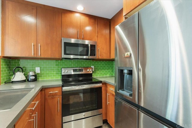 2224 River Run Dr Unit 154, San Diego, CA 92108 - kitchen with stainless steel appliances, brown cabinets, backsplash, and recessed lighting
