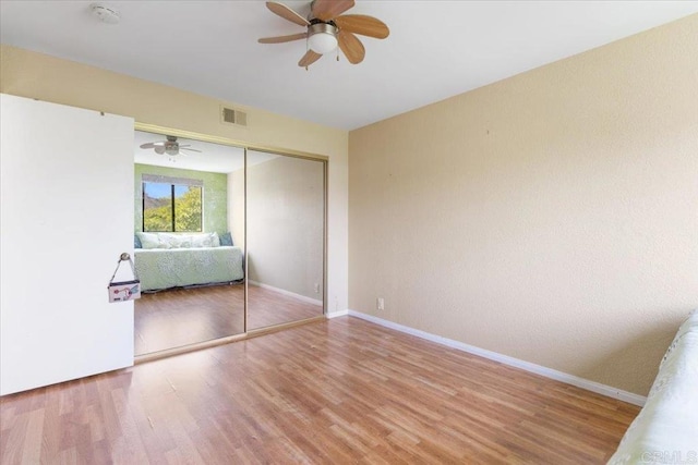 2224 River Run Dr Unit 154, San Diego, CA 92108 - unfurnished bedroom with wood finished floors, a closet, and a ceiling fan