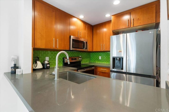 2224 River Run Dr Unit 154, San Diego, CA 92108 - kitchen featuring appliances with stainless steel finishes, brown cabinetry, backsplash, recessed lighting, and a peninsula