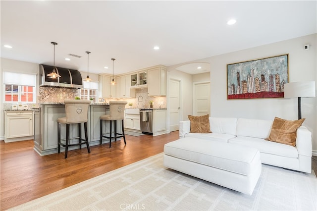 4022 Willowcrest Ave, Studio City, CA 91604 - living area featuring light wood-style floors, arched walkways, and recessed lighting