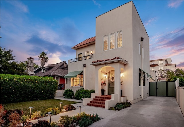4022 Willowcrest Ave, Studio City, CA 91604 - view of front of house with a balcony, a gate, stucco siding, and a tiled roof
