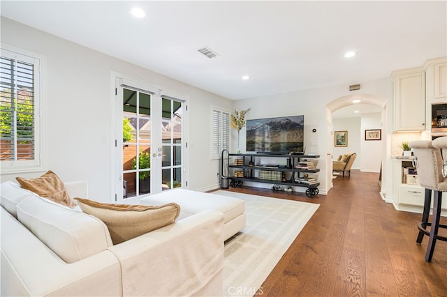 4022 Willowcrest Ave, Studio City, CA 91604 - living area featuring arched walkways, recessed lighting, healthy amount of natural light, and dark wood-style flooring