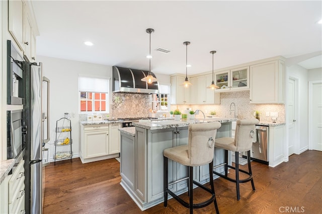 4022 Willowcrest Ave, Studio City, CA 91604 - kitchen featuring wall chimney exhaust hood, dark wood-style floors, stainless steel appliances, backsplash, and recessed lighting