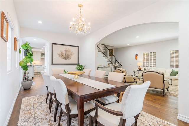4022 Willowcrest Ave, Studio City, CA 91604 - dining room featuring arched walkways, stairs, wood finished floors, recessed lighting, and a chandelier