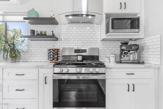 4255 Raynol St, Los Angeles, CA 90032 - kitchen with stainless steel appliances, range hood, tasteful backsplash, and white cabinets
