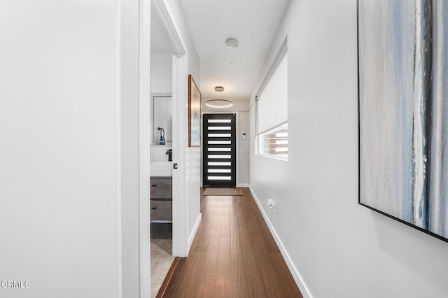 4255 Raynol St, Los Angeles, CA 90032 - hallway featuring dark wood finished floors and baseboards