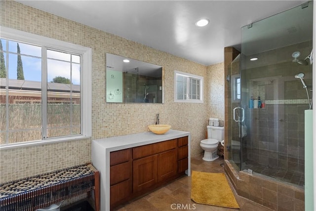 17172 Lahey St, Granada Hills, CA 91344 - full bathroom featuring tile walls, vanity, a stall shower, decorative backsplash, and tile patterned flooring