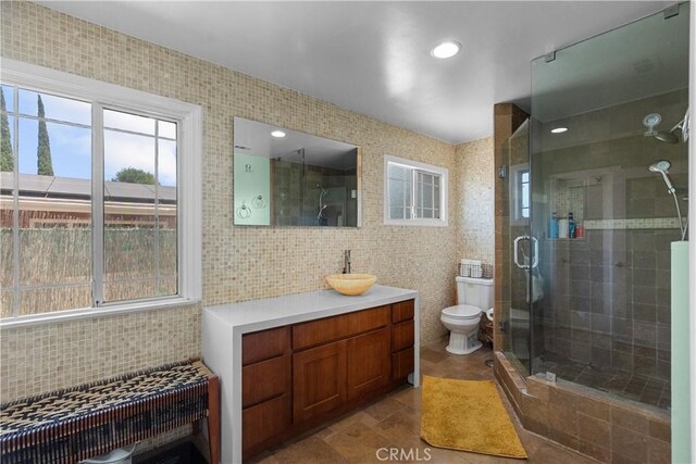 17172 Lahey St, Granada Hills, CA 91344 - full bathroom with tile walls, vanity, a stall shower, backsplash, and tile patterned flooring
