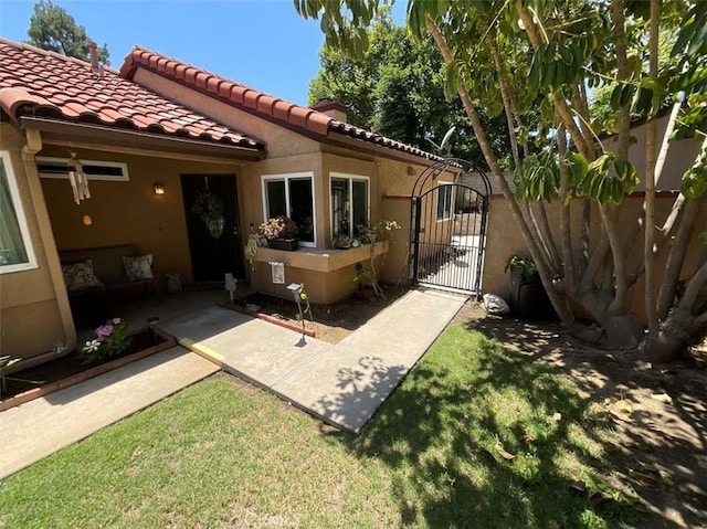 6720 Shaded Wood Pl, Rancho Cucamonga, CA 91701 - rear view of property featuring a gate, stucco siding, and a tiled roof