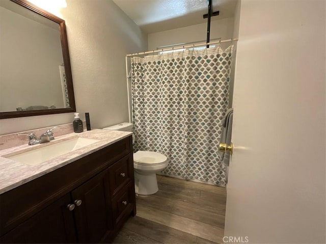 6720 Shaded Wood Pl, Rancho Cucamonga, CA 91701 - bathroom featuring wood finished floors, vanity, curtained shower, and a textured wall