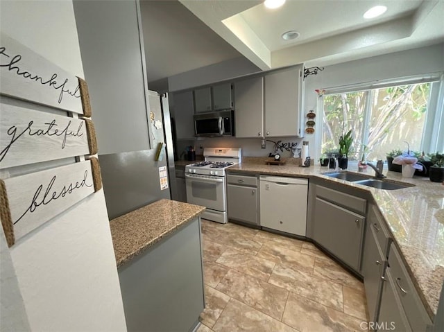 6720 Shaded Wood Pl, Rancho Cucamonga, CA 91701 - kitchen featuring white appliances, a raised ceiling, gray cabinetry, and recessed lighting