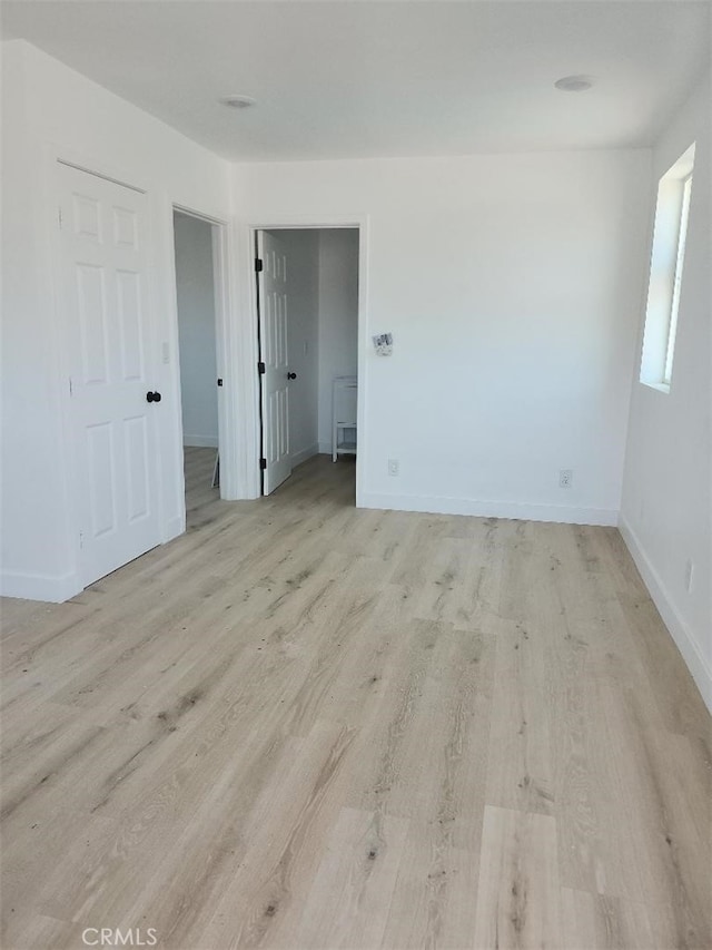 10531 Alexander Ave, South Gate, CA 90280 - unfurnished room with light wood-type flooring and baseboards