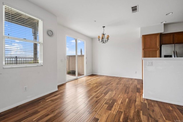 6410 Terraza Portico, Carlsbad, CA 92009 - unfurnished living room featuring a chandelier and wood finished floors
