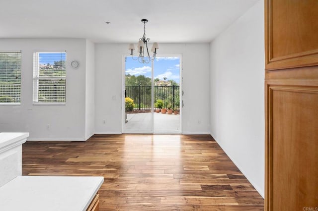 6410 Terraza Portico, Carlsbad, CA 92009 - unfurnished dining area featuring a chandelier and wood finished floors