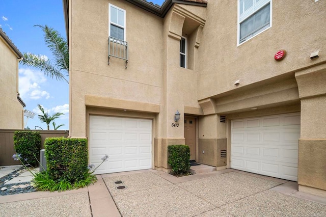 6410 Terraza Portico, Carlsbad, CA 92009 - view of front of home with stucco siding and a garage