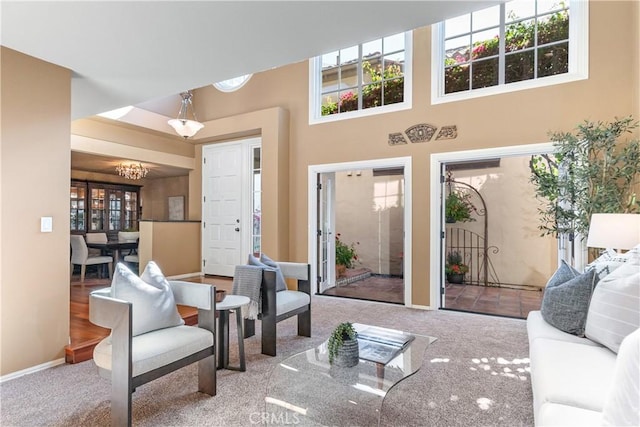 5620 La Paz St, Long Beach, CA 90803 - living room featuring carpet, a chandelier, and a high ceiling