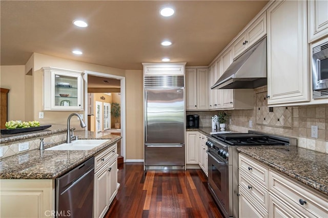 5620 La Paz St, Long Beach, CA 90803 - kitchen featuring built in appliances, under cabinet range hood, dark wood-style flooring, backsplash, and recessed lighting