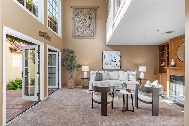 5620 La Paz St, Long Beach, CA 90803 - living area featuring plenty of natural light, a towering ceiling, carpet floors, and a fireplace