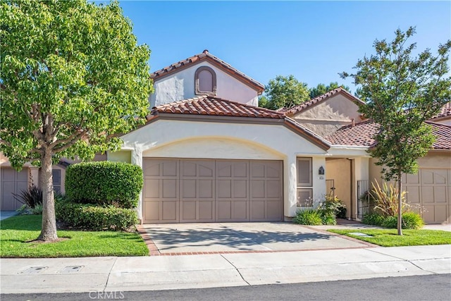 5620 La Paz St, Long Beach, CA 90803 - mediterranean / spanish home with concrete driveway, an attached garage, and stucco siding