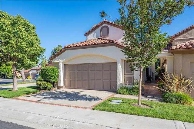 5620 La Paz St, Long Beach, CA 90803 - mediterranean / spanish-style home with a tiled roof, stucco siding, concrete driveway, and a garage