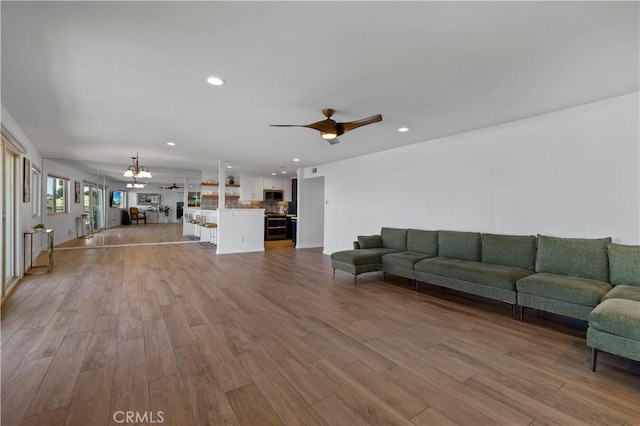 2700 E Panorama Dr Unit 208, Signal Hill, CA 90755 - living room with recessed lighting, wood finished floors, ceiling fan, and a chandelier