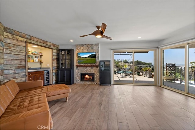 2700 E Panorama Dr Unit 208, Signal Hill, CA 90755 - unfurnished living room featuring beverage cooler, wood finished floors, a ceiling fan, a fireplace, and recessed lighting