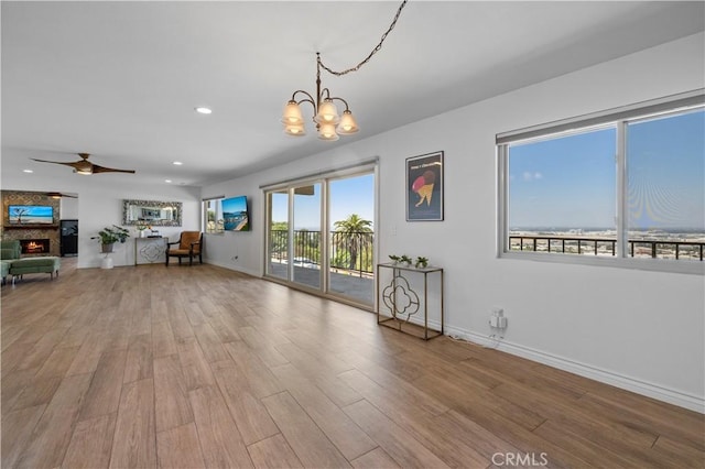 2700 E Panorama Dr Unit 208, Signal Hill, CA 90755 - living area with a chandelier, a large fireplace, a ceiling fan, wood finished floors, and recessed lighting