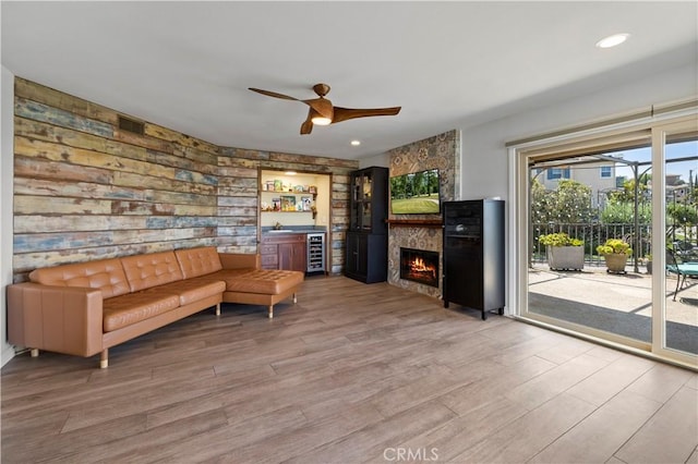 2700 E Panorama Dr Unit 208, Signal Hill, CA 90755 - living area featuring beverage cooler, a ceiling fan, wood finished floors, and a fireplace