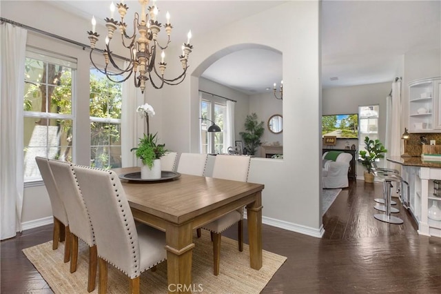 6 Via Amanti, Newport Coast, CA 92657 - dining space with arched walkways, a chandelier, and dark wood-style floors