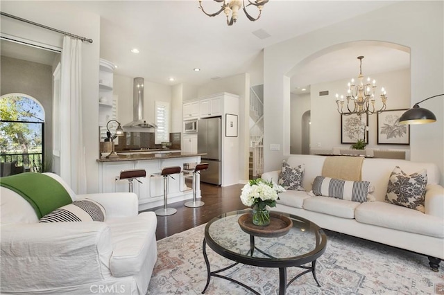 6 Via Amanti, Newport Coast, CA 92657 - living area featuring a chandelier, arched walkways, healthy amount of natural light, wood finished floors, and recessed lighting