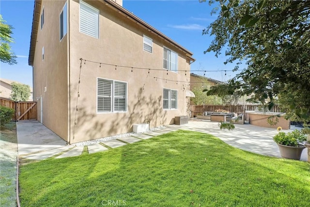 7059 E Monaco, Orange, CA 92867 - back of house with a patio, a fenced backyard, stucco siding, and an outdoor living space