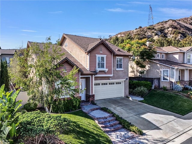 7059 E Monaco, Orange, CA 92867 - traditional home featuring an attached garage, driveway, a tiled roof, a mountain view, and stucco siding