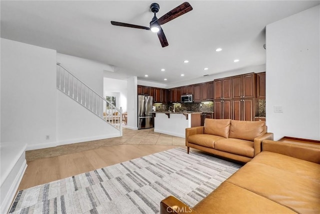 7059 E Monaco, Orange, CA 92867 - living room featuring a ceiling fan, light wood-style flooring, stairway, and recessed lighting