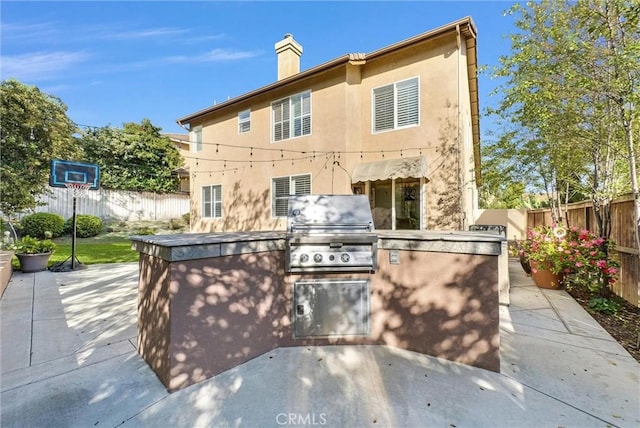 7059 E Monaco, Orange, CA 92867 - fenced backyard with a patio area and an outdoor kitchen