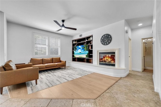 7059 E Monaco, Orange, CA 92867 - living room featuring ceiling fan, a glass covered fireplace, built in features, and recessed lighting