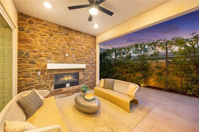 56 Cartwheel, Irvine, CA 92618 - patio terrace at dusk featuring a patio area, ceiling fan, and an outdoor living space with a fireplace
