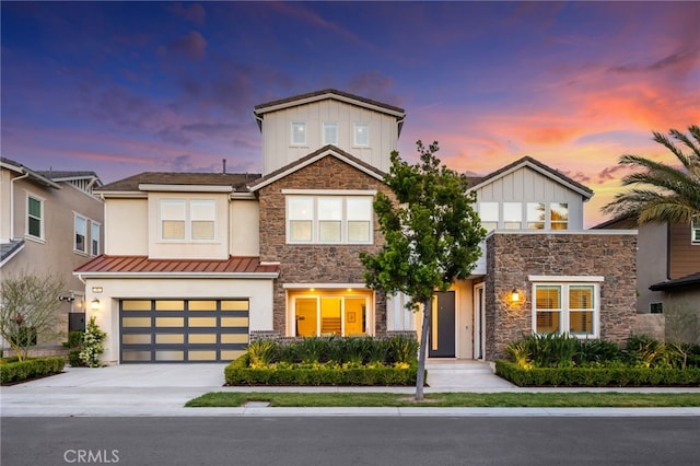 56 Cartwheel, Irvine, CA 92618 - view of front of home with stone siding, concrete driveway, a garage, board and batten siding, and a standing seam roof