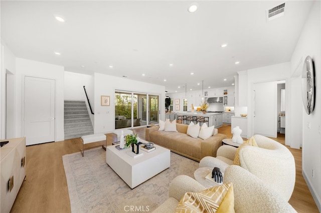 56 Cartwheel, Irvine, CA 92618 - living area featuring light wood-type flooring, stairs, and recessed lighting