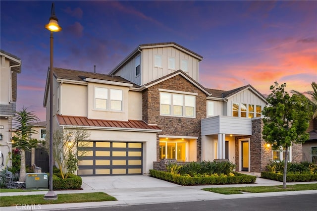 56 Cartwheel, Irvine, CA 92618 - view of front facade with stone siding, board and batten siding, driveway, stucco siding, and a garage