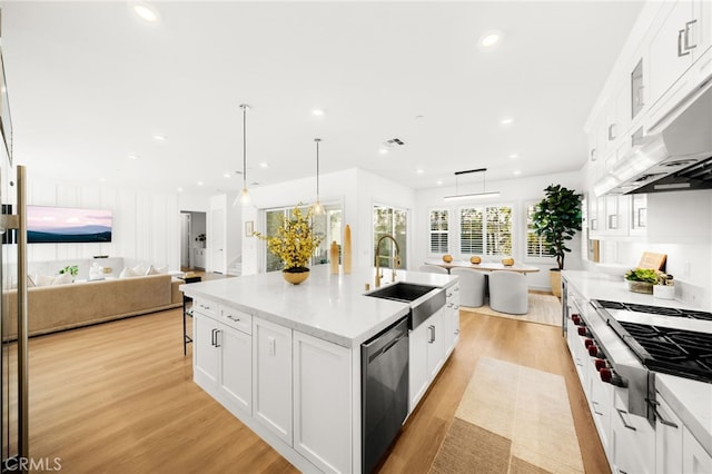 56 Cartwheel, Irvine, CA 92618 - kitchen with appliances with stainless steel finishes, open floor plan, light wood-type flooring, under cabinet range hood, and recessed lighting