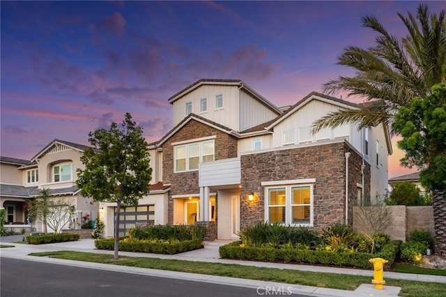56 Cartwheel, Irvine, CA 92618 - view of front of property with stone siding, a garage, and concrete driveway