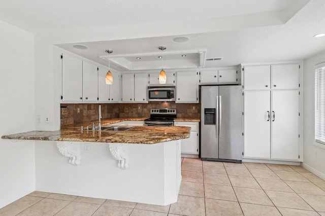 10559 Lansford Ln, San Diego, CA 92126 - kitchen featuring stainless steel appliances, a raised ceiling, tasteful backsplash, a peninsula, and stone countertops