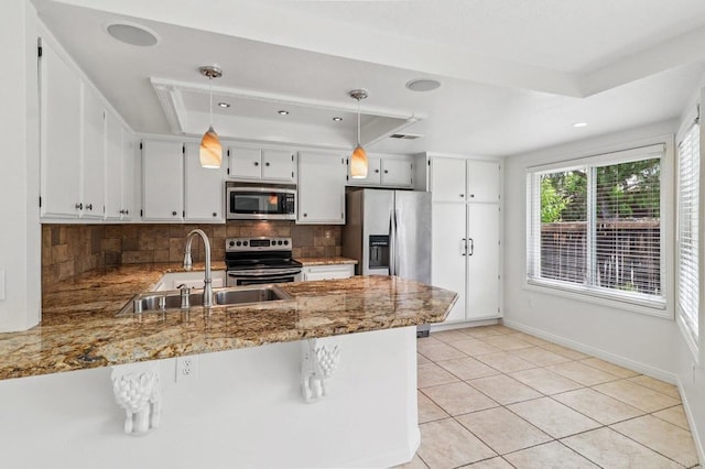 10559 Lansford Ln, San Diego, CA 92126 - kitchen featuring appliances with stainless steel finishes, a raised ceiling, a peninsula, tasteful backsplash, and stone counters