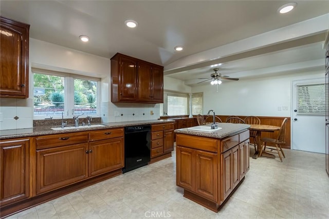 1835 Las Flores Dr, Glendale, CA 91207 - kitchen with black dishwasher, dark stone countertops, a ceiling fan, light flooring, and decorative backsplash