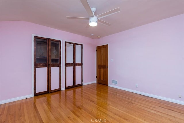 1835 Las Flores Dr, Glendale, CA 91207 - unfurnished bedroom with light wood-style flooring, multiple closets, and ceiling fan