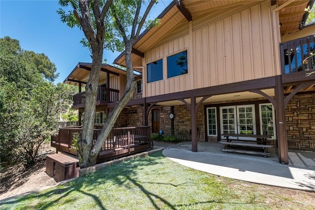 1835 Las Flores Dr, Glendale, CA 91207 - back of property with board and batten siding, stone siding, a patio, and a balcony