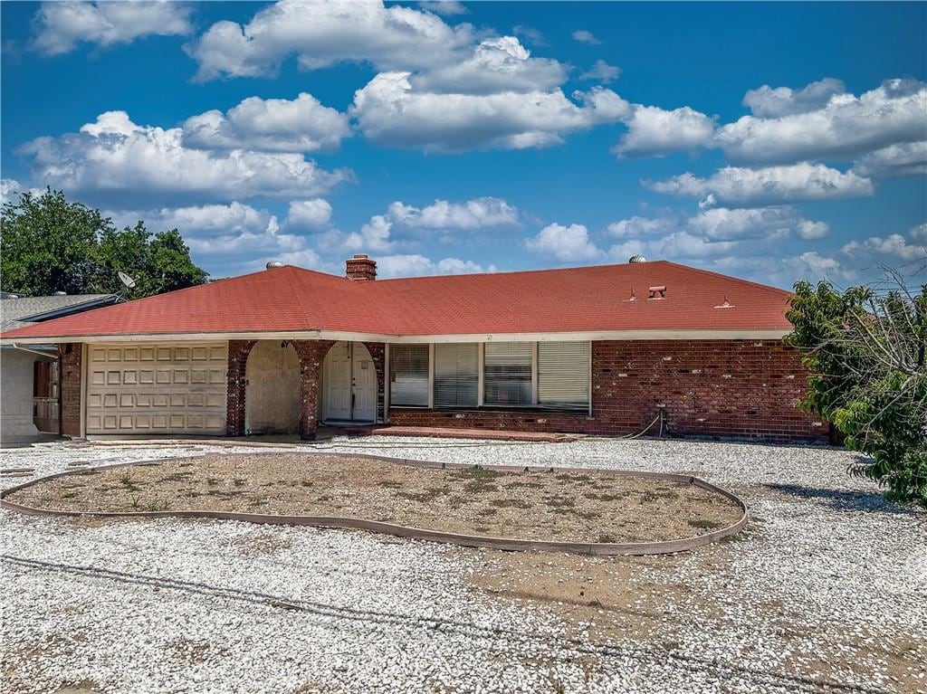 27190 Columbia St, Hemet, CA 92544 - ranch-style house with a garage, brick siding, driveway, and a chimney