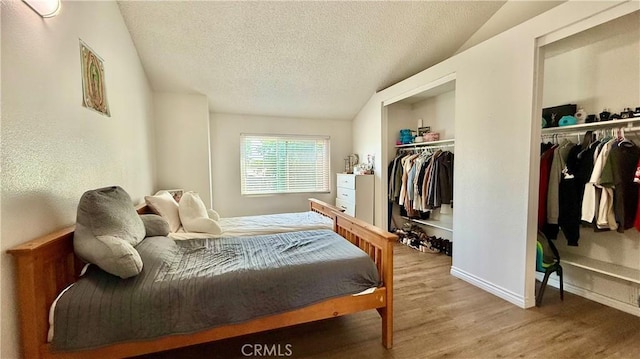 681 N Lark Ellen Ave, Covina, CA 91722 - bedroom with wood finished floors, a textured ceiling, and multiple closets