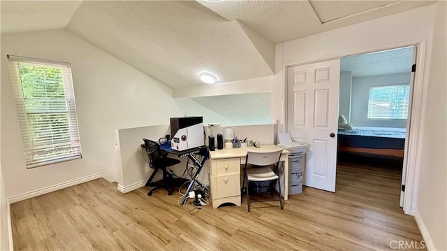 681 N Lark Ellen Ave, Covina, CA 91722 - home office with light wood-style flooring, lofted ceiling, healthy amount of natural light, and a textured ceiling