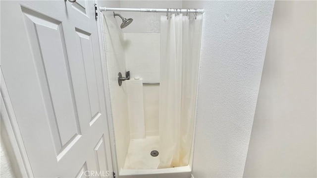 681 N Lark Ellen Ave, Covina, CA 91722 - bathroom featuring a textured wall and a shower stall